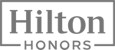 The image shows the Hilton Honors logo, featuring the words "Hilton Honors" in a simple, bold font within a rectangular frame.
